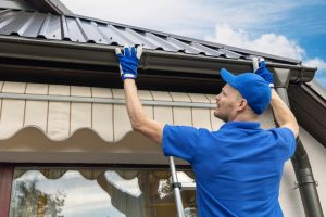 man checking gutters