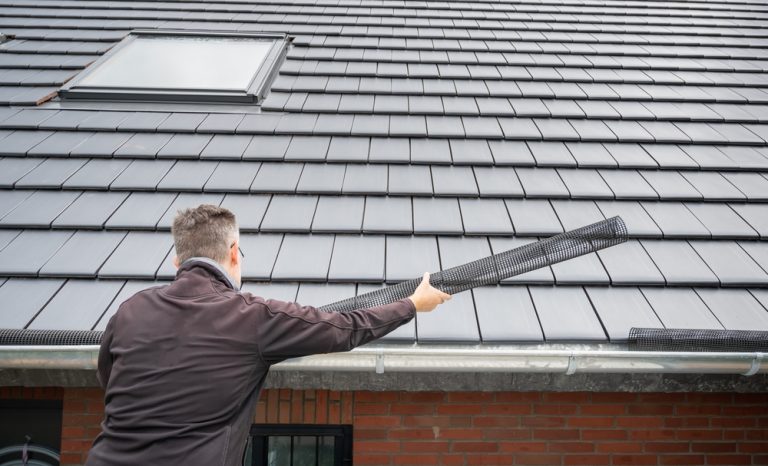 worker installing gutter system